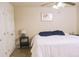 Bright bedroom features a ceiling fan, neutral walls, and a comfortable bed with blue pillows at 441 E Encinas Ave, Gilbert, AZ 85234