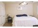 Bright bedroom features a ceiling fan, neutral walls, and a comfortable bed with blue pillows at 441 E Encinas Ave, Gilbert, AZ 85234