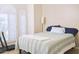 Bright bedroom with shuttered windows and a plush throw on the modern striped comforter at 441 E Encinas Ave, Gilbert, AZ 85234