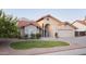 Inviting home exterior featuring manicured lawn, shrubbery, and an arched entry at 441 E Encinas Ave, Gilbert, AZ 85234