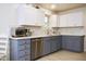 Updated kitchen with stainless steel appliances, quartz countertops, and modern cabinetry at 441 E Encinas Ave, Gilbert, AZ 85234
