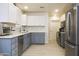 Well-lit kitchen featuring stainless appliances, modern white upper cabinets, and grey lower cabinets at 441 E Encinas Ave, Gilbert, AZ 85234