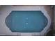 Aerial view of a backyard swimming pool with a unique shape and integrated lighting at 441 E Encinas Ave, Gilbert, AZ 85234