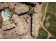 Overhead view of a residential community featuring a sparkling blue pool, lush greenery, and ample parking at 4455 E Paradise Village Pkwy # 1051, Phoenix, AZ 85032