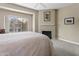 Bedroom with fireplace, neutral walls, and large window with neighborhood views at 4455 E Paradise Village Pkwy # 1051, Phoenix, AZ 85032