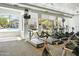 Well-equipped gym featuring treadmills, stationary bikes, and large windows with pool view at 4455 E Paradise Village Pkwy # 1051, Phoenix, AZ 85032