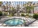 Inviting hot tub area with lush landscaping, pergola, and view of the pool at 4455 E Paradise Village Pkwy # 1051, Phoenix, AZ 85032