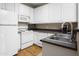 Well-maintained kitchen featuring white appliances, ample cabinet space, and modern sink at 4455 E Paradise Village Pkwy # 1051, Phoenix, AZ 85032