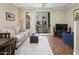 Comfortable living area with a modern sofa, entertainment center, and sliding glass doors to balcony at 4455 E Paradise Village Pkwy # 1051, Phoenix, AZ 85032