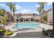 Resort-style pool surrounded by palm trees, lounge chairs, and well-maintained landscaping at 4455 E Paradise Village Pkwy # 1051, Phoenix, AZ 85032