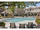 Beautiful pool area with lounge chairs, palm trees, and building views at 4455 E Paradise Village Pkwy # 1051, Phoenix, AZ 85032
