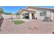 Spacious backyard features a rock landscape, turf accents, a covered patio, and perimeter block fencing at 46141 W Amsterdam Rd, Maricopa, AZ 85139