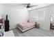 Well-lit bedroom features a ceiling fan, a window and light hardwood style flooring at 46141 W Amsterdam Rd, Maricopa, AZ 85139