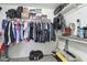 Walk-in closet with shelving, hanging racks, and carpet floors provides plenty of storage space at 46141 W Amsterdam Rd, Maricopa, AZ 85139