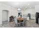 Open-concept dining area adjacent to the kitchen, with modern light fixture and wood-style flooring at 46141 W Amsterdam Rd, Maricopa, AZ 85139
