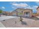 Charming single-story home with a well-manicured yard, desert landscaping, and a two-car garage at 46141 W Amsterdam Rd, Maricopa, AZ 85139