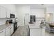 Bright kitchen with white cabinets, stainless steel appliances, and plenty of counter space at 46141 W Amsterdam Rd, Maricopa, AZ 85139