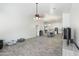 Expansive living room featuring open layout and wood-style flooring, seamlessly connecting living, dining, and kitchen areas at 46141 W Amsterdam Rd, Maricopa, AZ 85139
