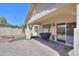 The covered patio features an outdoor grill area with easy access into the home through sliding glass doors at 46141 W Amsterdam Rd, Maricopa, AZ 85139