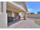 Covered patio with brick flooring, stainless steel BBQ, and access to the backyard at 46141 W Amsterdam Rd, Maricopa, AZ 85139
