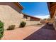 The backyard features a brick paver patio surrounded by desert landscaping, perfect for entertaining at 5221 E Tunder Cir, Phoenix, AZ 85044