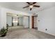 Bright bedroom features a ceiling fan, carpeted floors and a mirrored closet at 5221 E Tunder Cir, Phoenix, AZ 85044