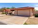 Single Gathering home featuring a red tile roof and a two-car garage at 5221 E Tunder Cir, Phoenix, AZ 85044