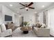 Bright living room featuring a ceiling fan, modern furniture and stylish decor and front door at 5221 E Tunder Cir, Phoenix, AZ 85044