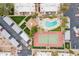 Overhead view of sparkling pool, spa, tennis court, carports, and lush landscaping in a desirable community at 536 S Evergreen Rd, Tempe, AZ 85288