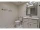 Clean bathroom with white cabinetry, modern mirror, sink, toilet, and a towel rack at 536 S Evergreen Rd, Tempe, AZ 85288