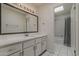 Bathroom with a bright skylight, a vanity with a big mirror and a shower with a patterned curtain at 536 S Evergreen Rd, Tempe, AZ 85288