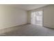 Bright bedroom with a sliding glass door, neutral carpet, and bright white walls at 536 S Evergreen Rd, Tempe, AZ 85288