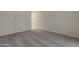 Neutral bedroom with gray carpet, a towel rack, and a bright white door at 536 S Evergreen Rd, Tempe, AZ 85288