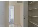 View of hallway with tile flooring and access to carpeted room with closet shelves at 536 S Evergreen Rd, Tempe, AZ 85288