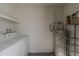 Inside laundry room with washer, dryer, water heater and metal shelves at 536 S Evergreen Rd, Tempe, AZ 85288