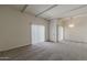 Spacious living room featuring neutral carpet, white walls, beamed ceilings, and a large window for ample natural light at 536 S Evergreen Rd, Tempe, AZ 85288