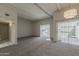 Comfortable living room with soft carpet, white walls, beamed ceilings, and sliding glass doors that open to the patio at 536 S Evergreen Rd, Tempe, AZ 85288