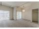 Inviting living space with cozy carpet, white walls, beamed ceilings, and sliding glass doors offering outdoor access at 536 S Evergreen Rd, Tempe, AZ 85288