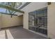 Enclosed patio featuring textured walls, a covered pergola, and sliding glass doors that lead to the interior of the home at 536 S Evergreen Rd, Tempe, AZ 85288