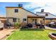 A spacious backyard features a lush lawn, covered patio, grill, and outdoor seating at 542 N Orlando Cir, Mesa, AZ 85205