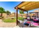 An outdoor patio features comfortable seating, string lights, fire pit, and grass at 542 N Orlando Cir, Mesa, AZ 85205