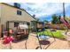 A charming backyard features a grassy area, a play area, and patio furniture at 542 N Orlando Cir, Mesa, AZ 85205