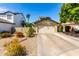 Charming home featuring a tan stucco facade, low maintenance landscaping, and two-car garage at 542 N Orlando Cir, Mesa, AZ 85205
