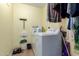 A well-lit laundry room is equipped with a washer and storage space for supplies at 542 N Orlando Cir, Mesa, AZ 85205