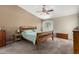 Serene main bedroom featuring a vaulted ceiling, a ceiling fan, and a large window at 542 N Orlando Cir, Mesa, AZ 85205