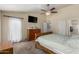 Comfortable main bedroom with a ceiling fan, dresser, and a door leading to the outside, offering seamless indoor-outdoor living at 542 N Orlando Cir, Mesa, AZ 85205