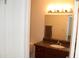 Bathroom vanity features a brown cabinet and granite countertop; mirror and lighting included at 5877 N Granite Reef Rd # 2257, Scottsdale, AZ 85250