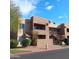 Inviting two-story exterior showcases balconies, desert landscaping, and a classic, Southwestern-style architectural charm at 5877 N Granite Reef Rd # 2257, Scottsdale, AZ 85250