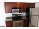 Updated kitchen with stainless steel appliances, dark wood cabinetry, and granite countertops, offering a sleek design at 5877 N Granite Reef Rd # 2257, Scottsdale, AZ 85250
