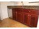 A kitchen featuring wooden cabinets, granite counters, and a stainless steel dishwasher at 5877 N Granite Reef Rd # 2257, Scottsdale, AZ 85250